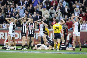 Players react after the siren sounds at the end of the 2010 AFL grand final.